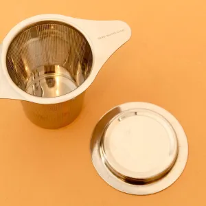 STAINLESS STEEL TEA STEEPER STRAINER SITS ON MUG